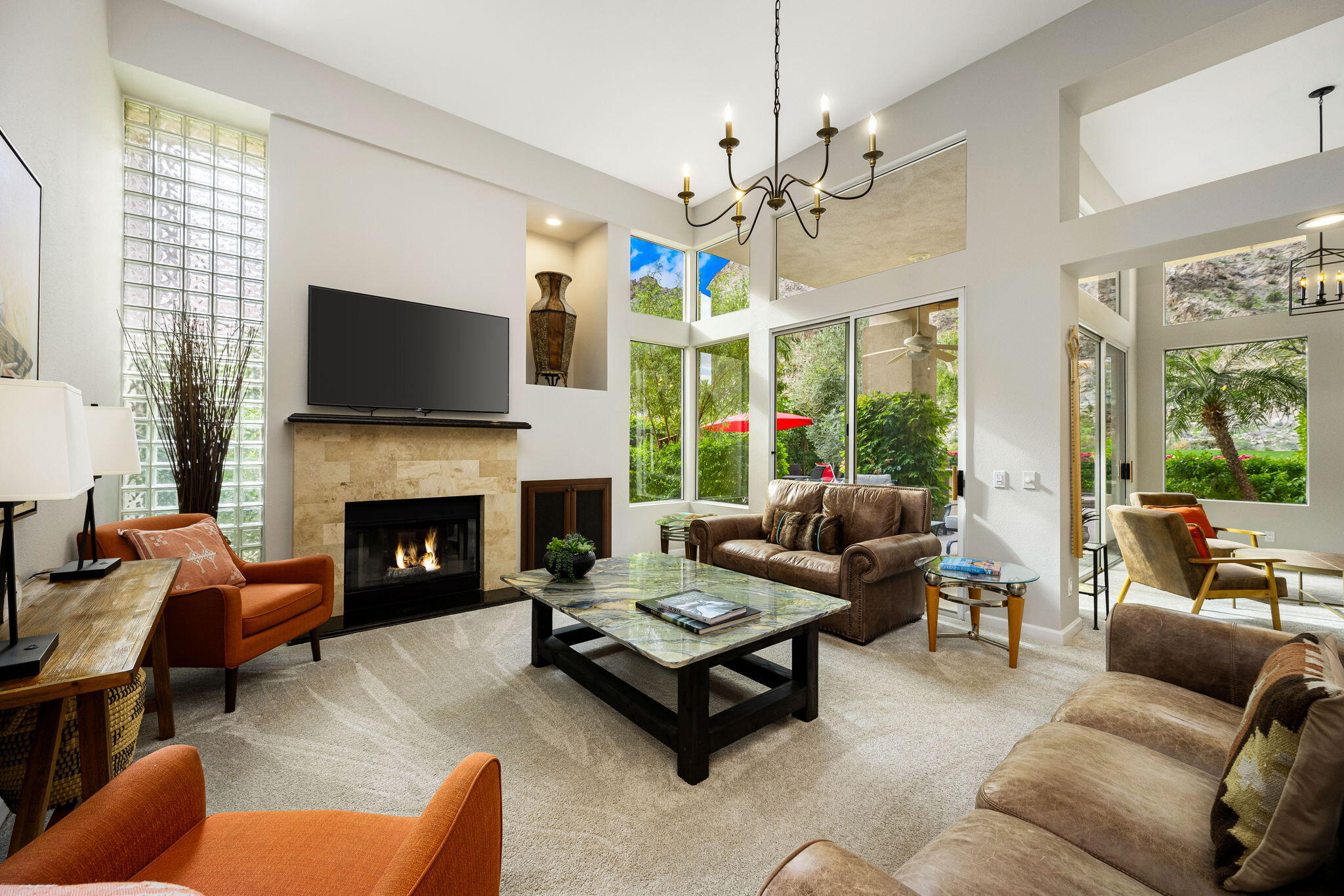 55685 Riviera La Quinta, CA 92253 - Photo 10 of 75 a living room with furniture a flat screen tv and a fireplace