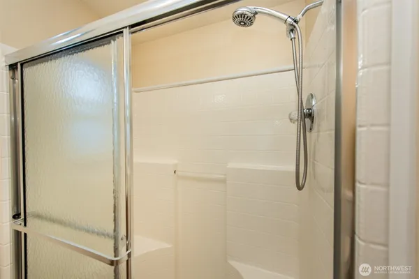a bathroom with a glass shower door