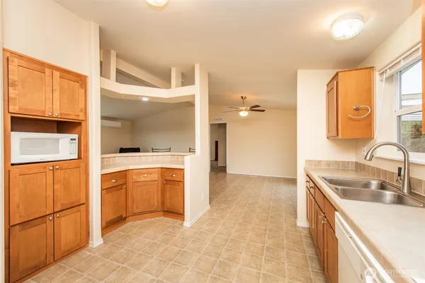 a kitchen with granite countertop a sink and cabinets