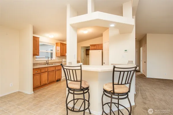 a kitchen with a table chairs and entryway