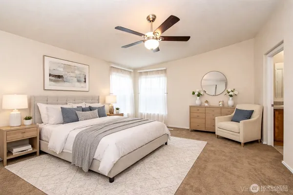 a bedroom with bed and white couch
