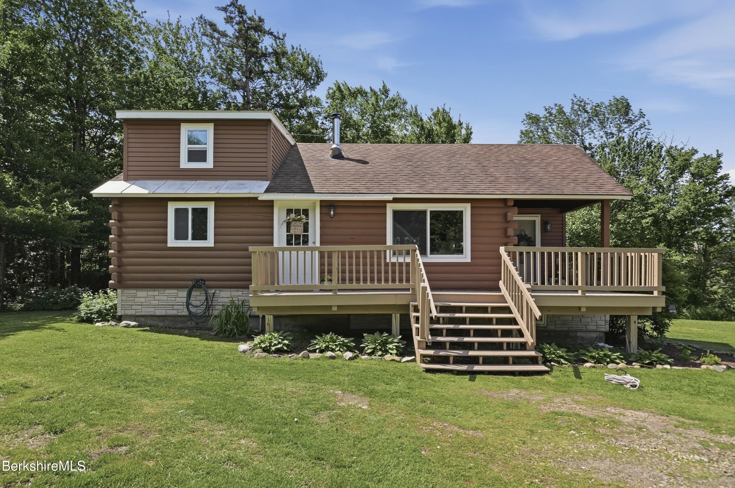 4 David Drive Peru, MA 01235 - Photo 4 of 44 a front view of a house with a yard