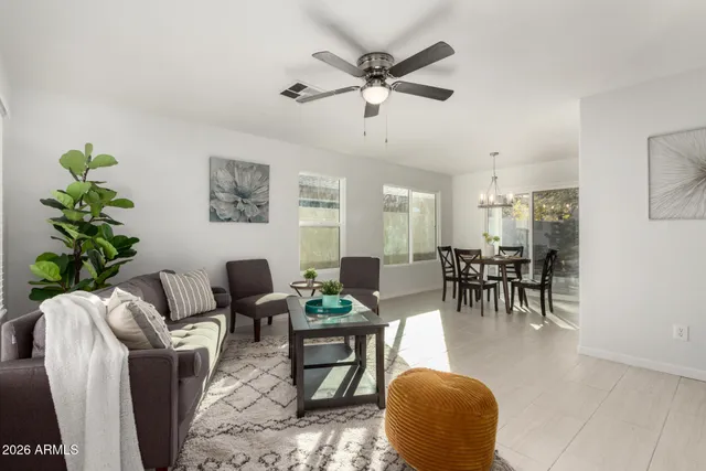 a living room with furniture and a chandelier