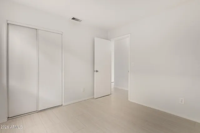 a bathroom with a granite countertop toilet a sink and a mirror