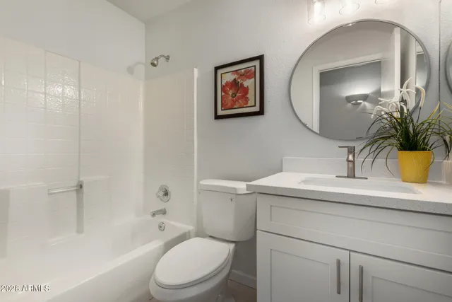 a view of a patio with table and chairs and a barbeque
