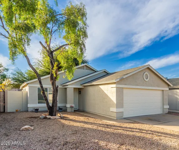 a view of a house with a tree in the background