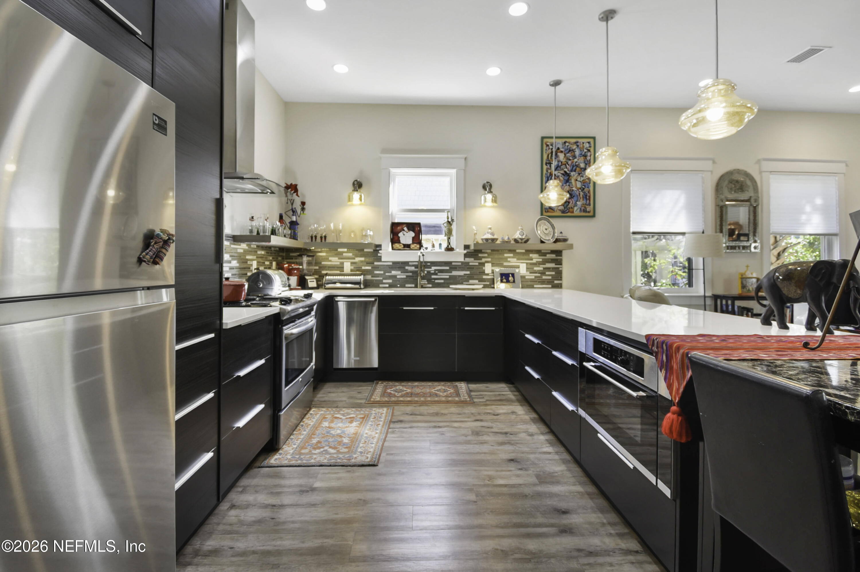 307 St George Street St. Augustine, FL 32084 - Photo 11 of 44 a kitchen with stainless steel appliances granite countertop wooden cabinets and sink