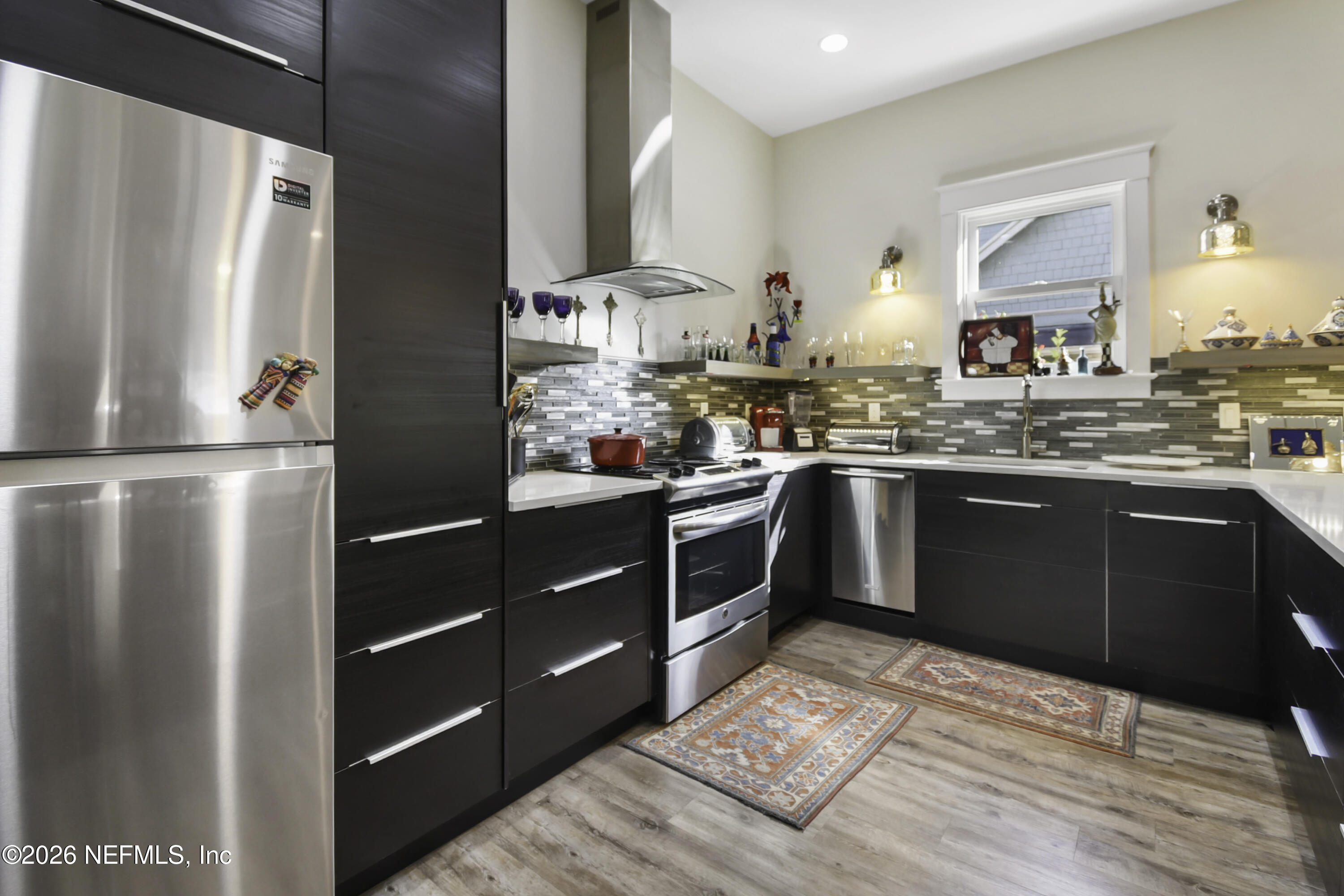 307 St George Street St. Augustine, FL 32084 - Photo 12 of 44 a kitchen with stainless steel appliances granite countertop a sink stove and refrigerator