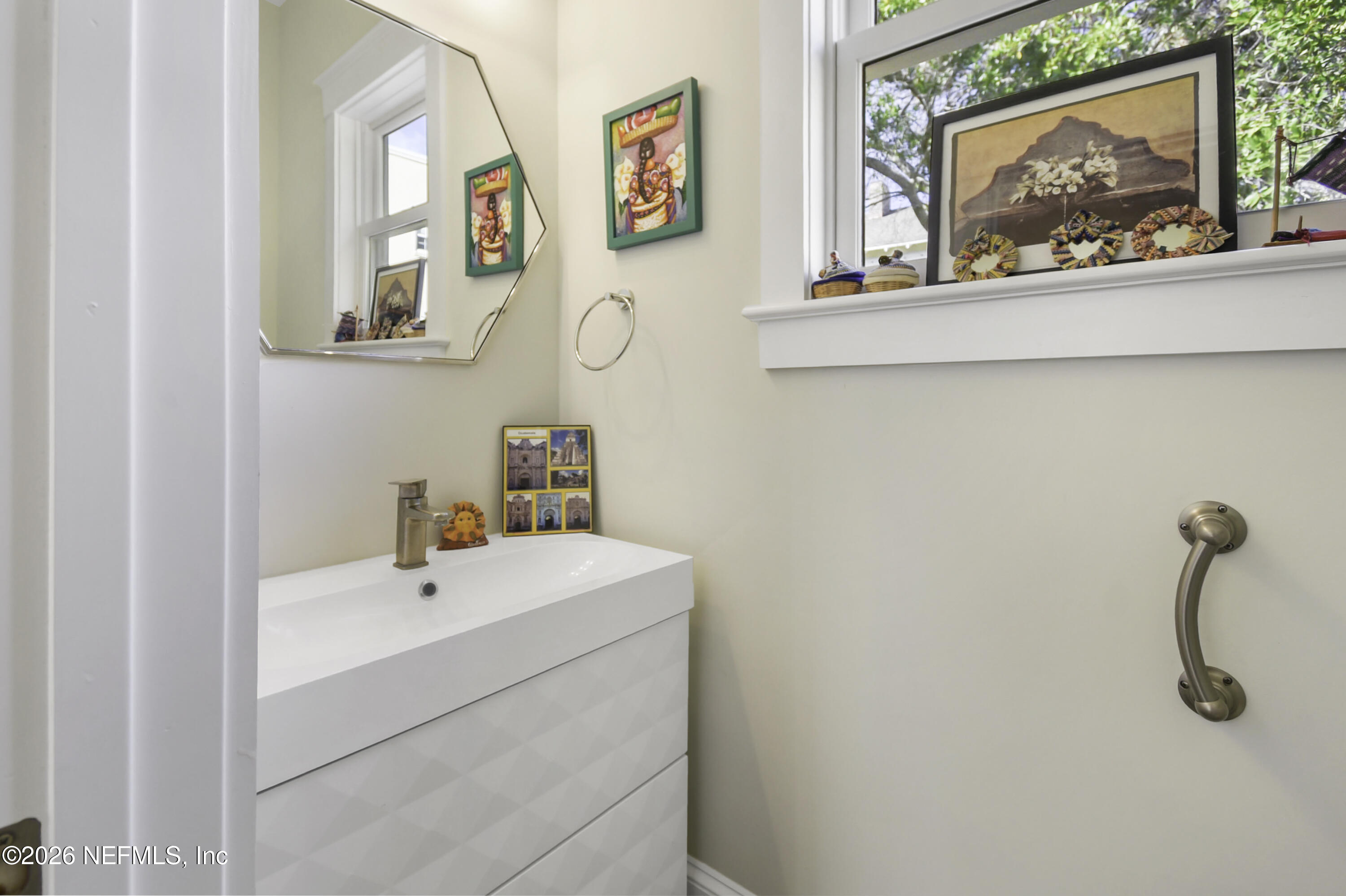 307 St George Street St. Augustine, FL 32084 - Photo 15 of 44 a bathroom with a sink mirror and a picture on the wall