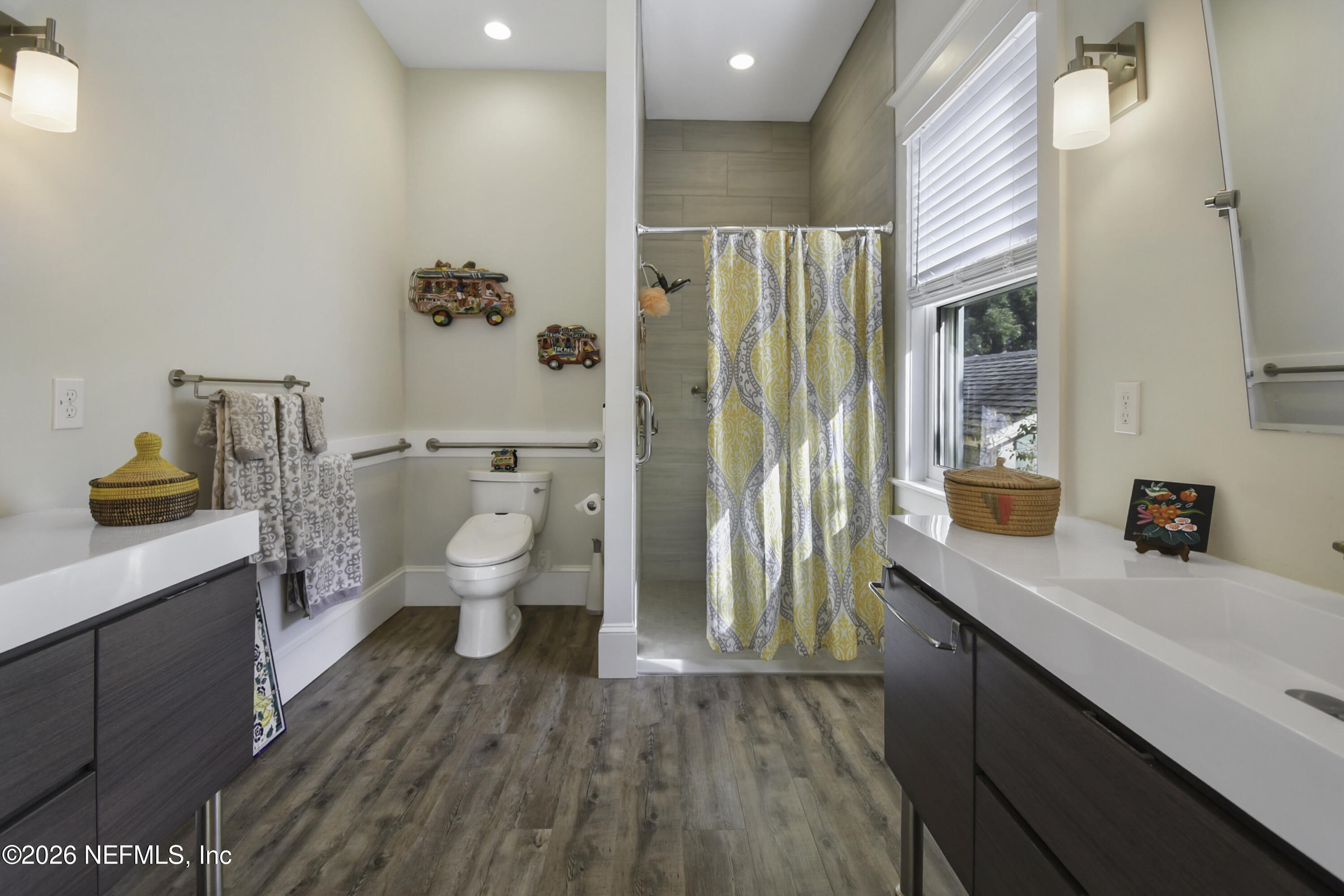 307 St George Street St. Augustine, FL 32084 - Photo 21 of 44 a bathroom with a sink a toilet a large mirror and shower