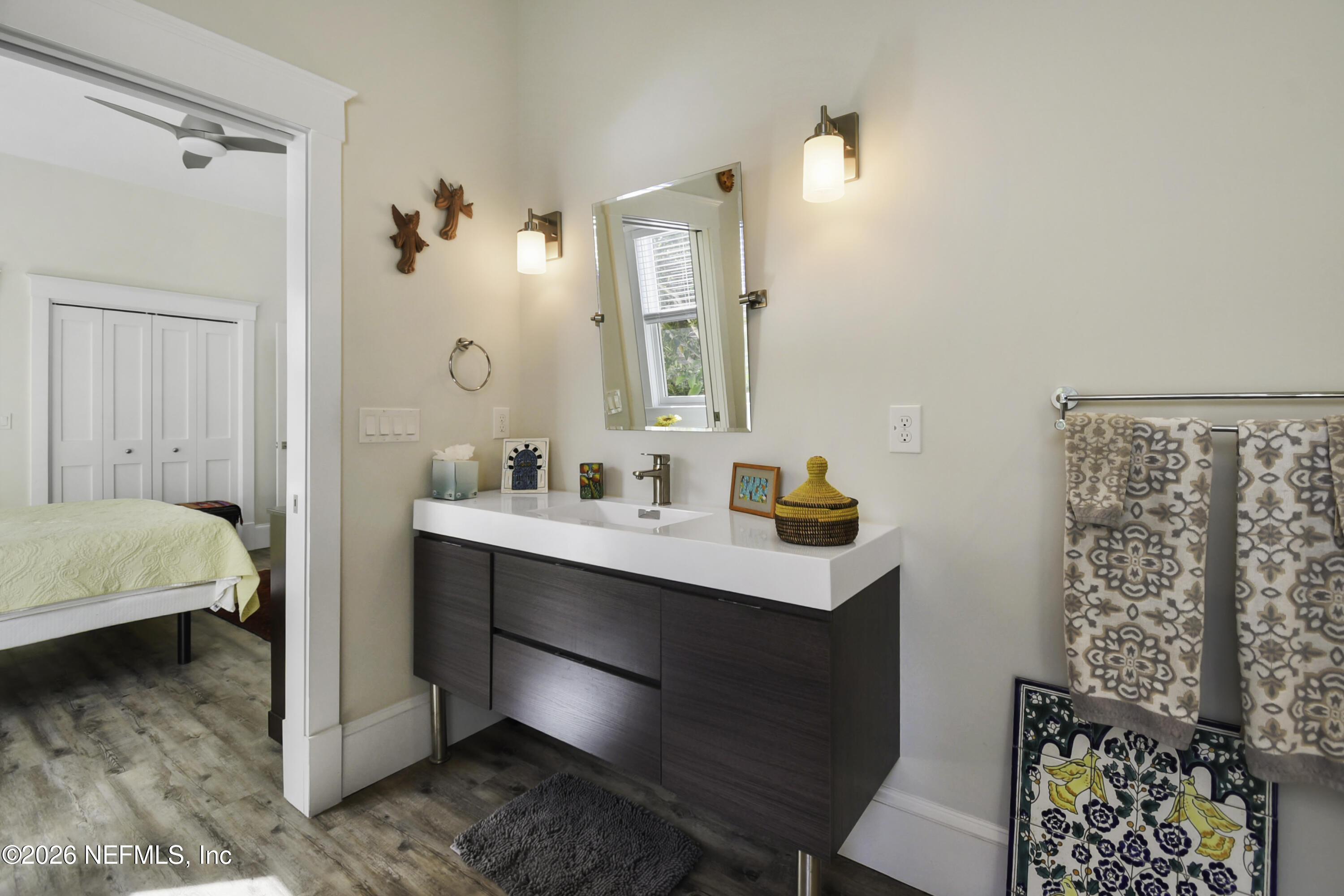 307 St George Street St. Augustine, FL 32084 - Photo 22 of 44 a en suite bathroom with a sink mirror and vanity