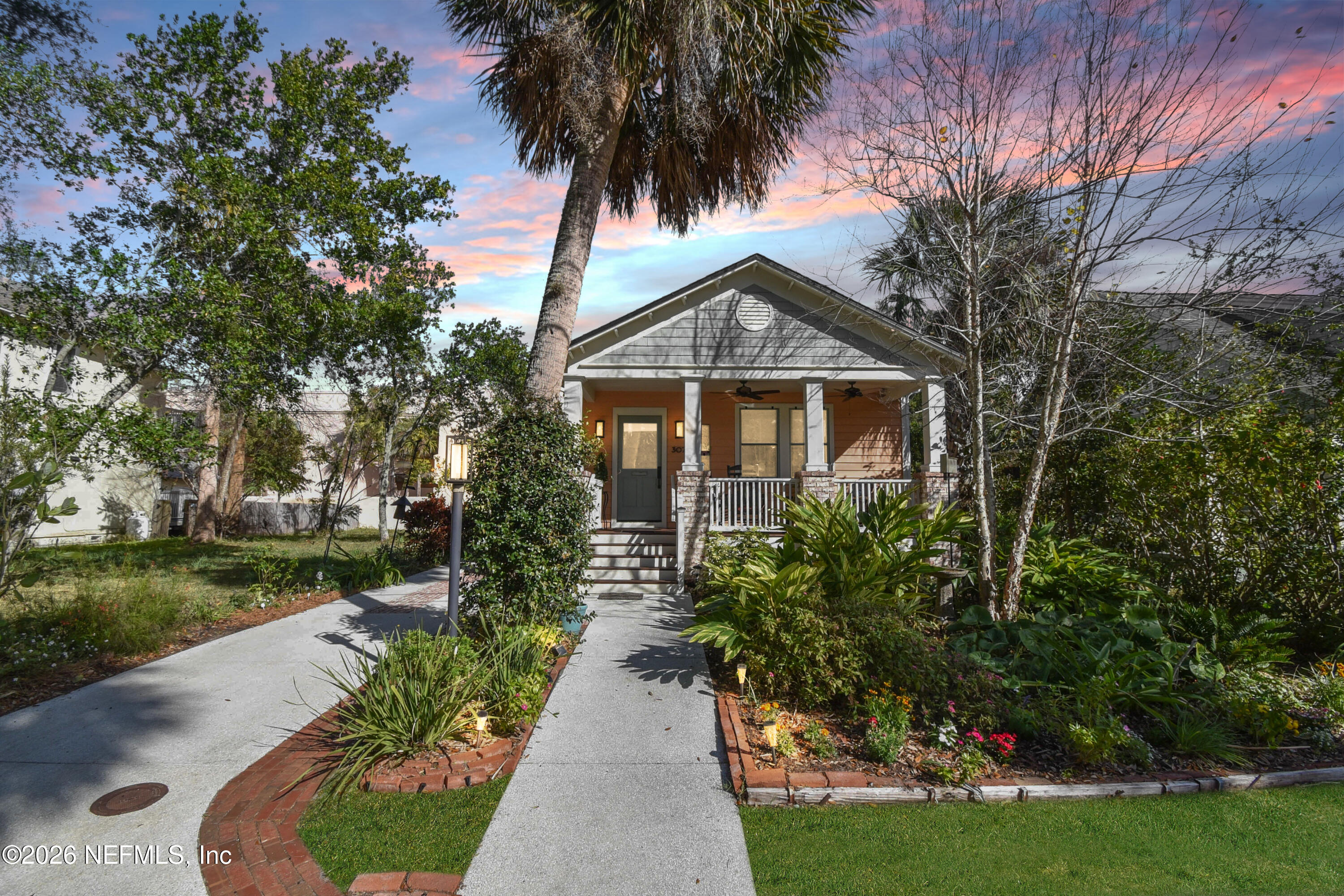 307 St George Street St. Augustine, FL 32084 - Photo 32 of 44 a front view of a house with a yard and potted plants