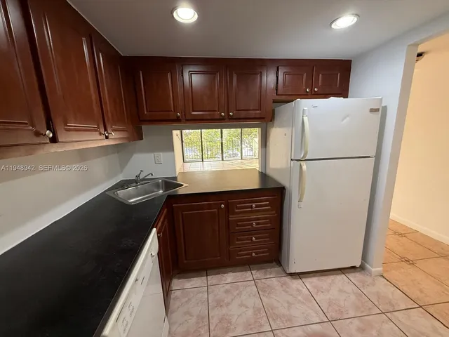 a kitchen with a refrigerator and a stove
