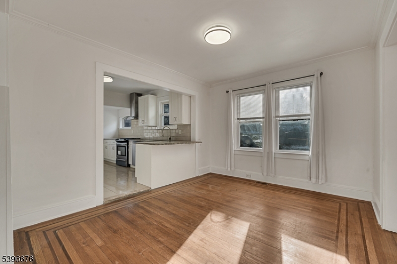 983 Colonial Avenue Union, NJ 07083 - Photo 16 of 28 a view of empty room with wooden floor and kitchen view