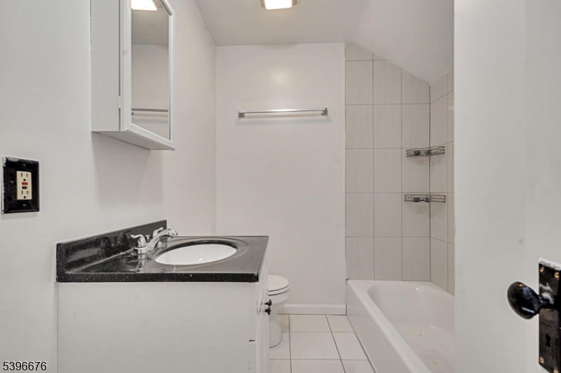 983 Colonial Avenue Union, NJ 07083 - Photo 6 of 28 a bathroom with a sink a mirror and a bathtub