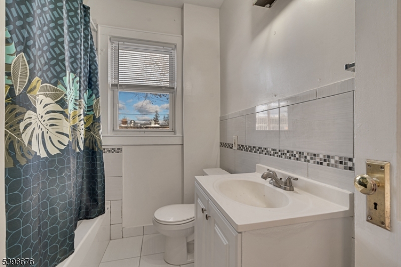 983 Colonial Avenue Union, NJ 07083 - Photo 10 of 28 a bathroom with a sink a toilet and shower