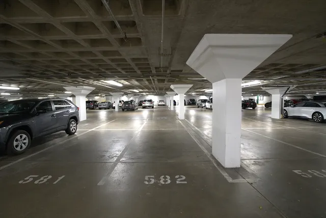 a view of parking garage with cars