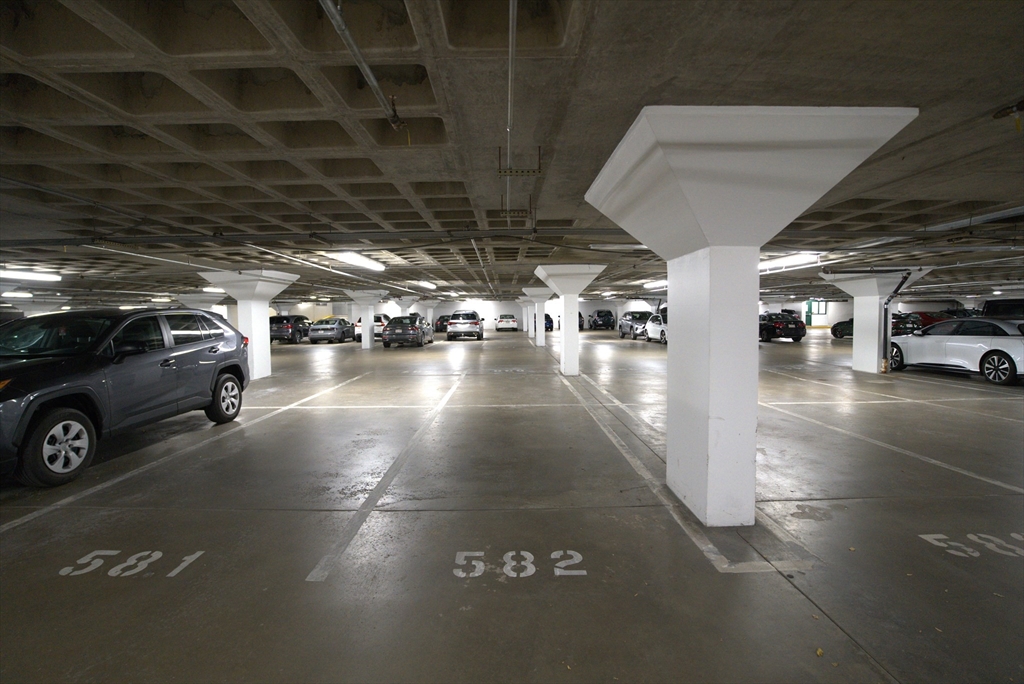 a view of parking garage with cars