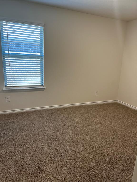 807 Cinnabar Way Princeton, TX 75407 - Photo 13 of 22 an empty room with a window