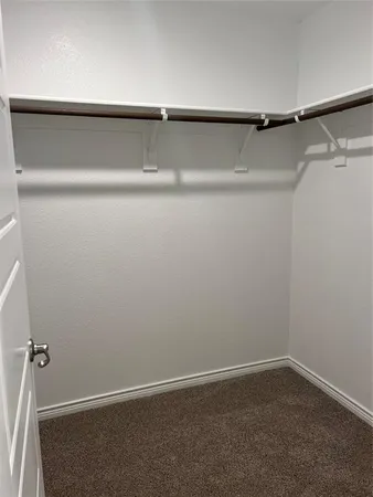 a view of a closet with wooden floor