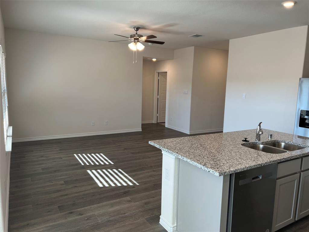 807 Cinnabar Way Princeton, TX 75407 - Photo 6 of 22 a kitchen with a sink a refrigerator and chandelier