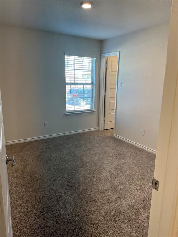 807 Cinnabar Way Princeton, TX 75407 - Photo 9 of 22 an empty room with windows