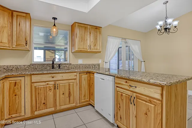 a kitchen with granite countertop a sink stainless steel appliances and cabinets