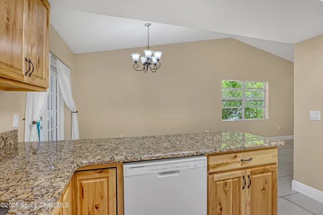 a view of a kitchen cabinets and chandelier