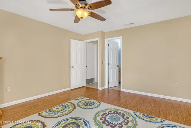 a bedroom with a bed and a wooden floor