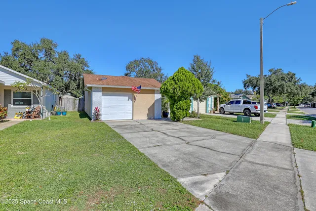 a front view of a house with a yard and a garage