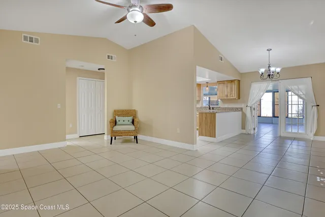 a view of a livingroom with furniture and a chandelier fan
