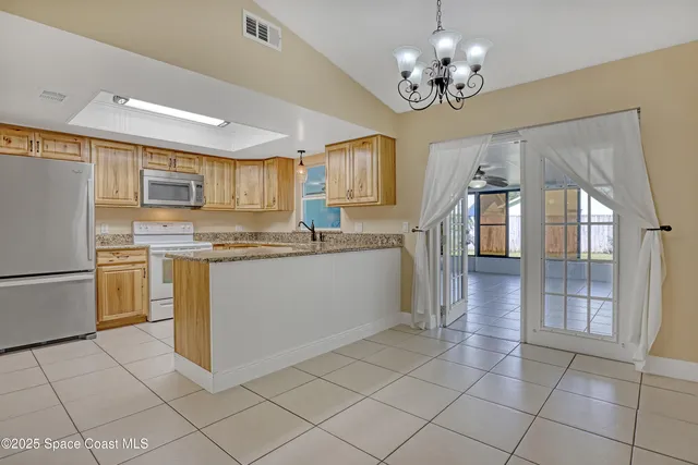 a kitchen with a stove a refrigerator and a sink