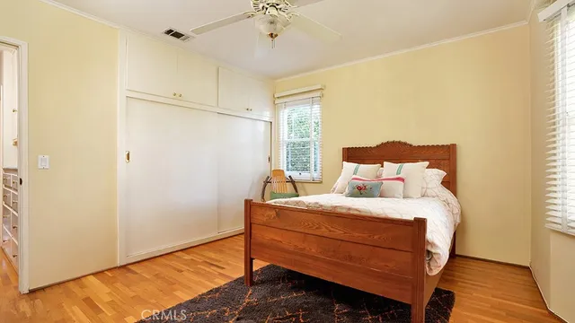 a view of a livingroom with wooden floor and a chandelier