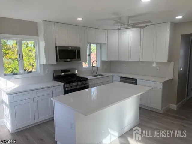 a kitchen with a sink a stove and cabinets