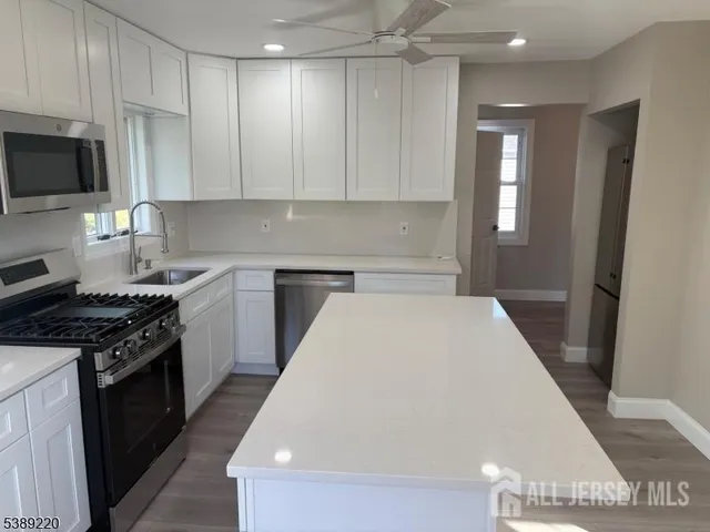a kitchen with a sink a stove and refrigerator