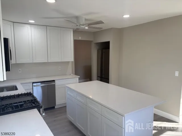 a kitchen with a sink a stove and cabinets