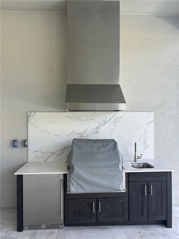 9475 Caymas Way Naples, FL 34114 - Photo 4 of 8 a living room with a sink and cabinets