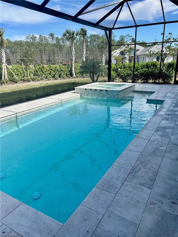 9475 Caymas Way Naples, FL 34114 - Photo 5 of 8 a view of a large pool with a yard