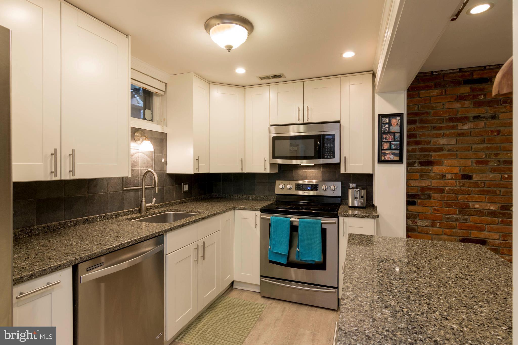 722 Genessee Street Annapolis, MD 21401 - Photo 11 of 29 a kitchen with stainless steel appliances granite countertop a stove a sink and a microwave