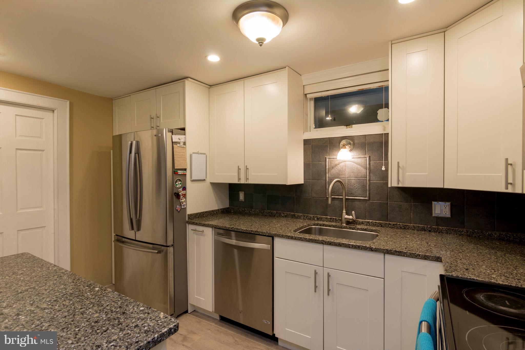 722 Genessee Street Annapolis, MD 21401 - Photo 13 of 29 a kitchen with stainless steel appliances granite countertop a refrigerator a stove and a sink with wooden floor