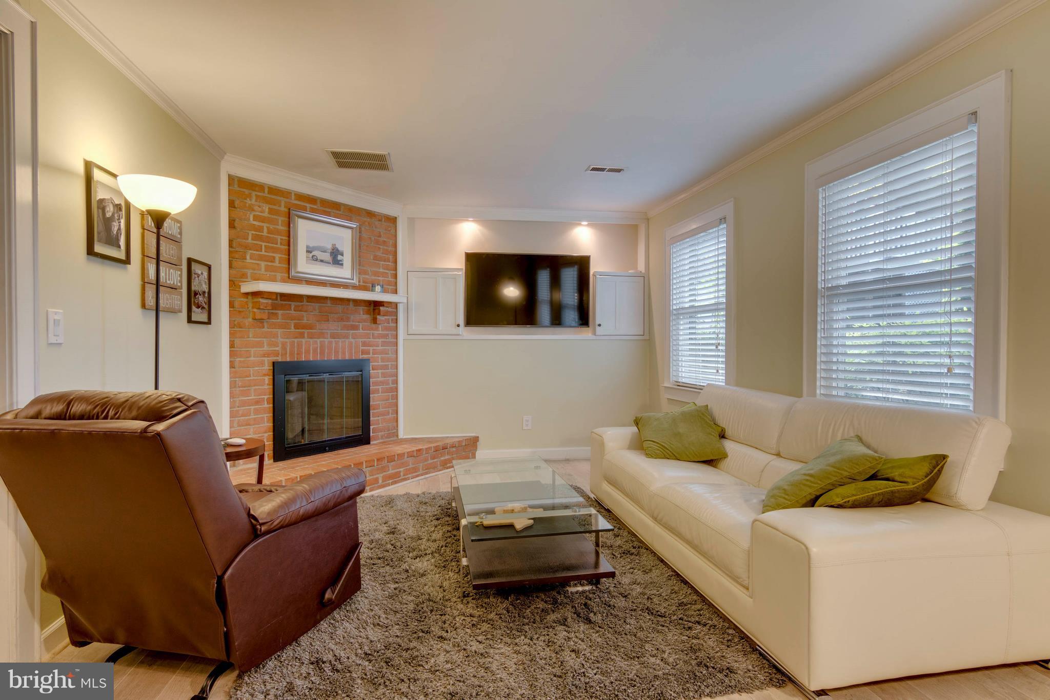 722 Genessee Street Annapolis, MD 21401 - Photo 4 of 29 a living room with furniture a flat screen tv and a fireplace