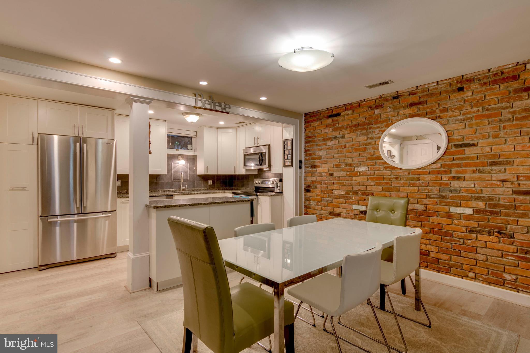 722 Genessee Street Annapolis, MD 21401 - Photo 8 of 29 a kitchen with stainless steel appliances granite countertop a dining table chairs sink and microwave