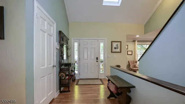 a kitchen with stainless steel appliances granite countertop a table chairs a sink and wooden floors