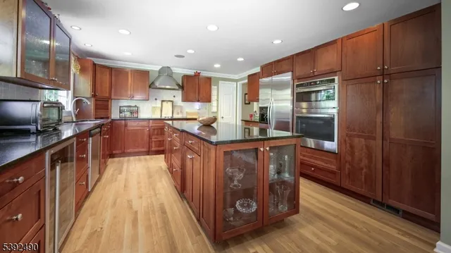 a dining room with furniture a chandelier and wooden floor