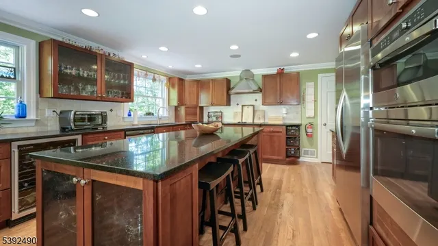 a kitchen with kitchen island granite countertop a sink counter top space appliances and cabinets