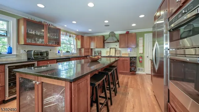 a living room with furniture floor to ceiling window and wooden floor