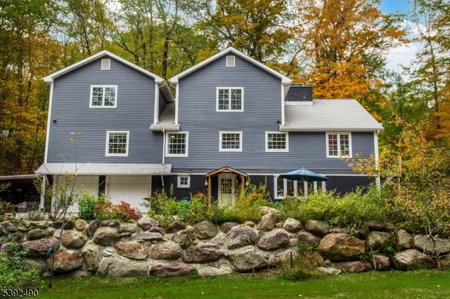 a front view of a house with a yard and trees