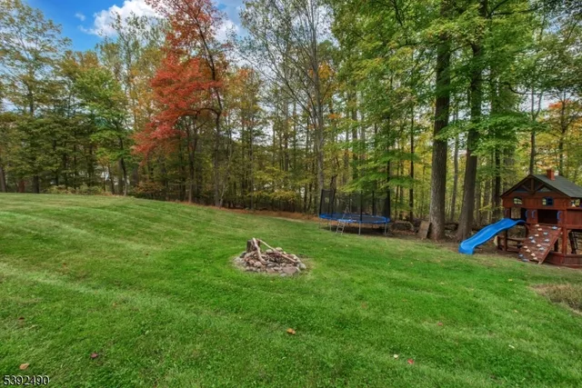 a view of a backyard with table and chairs and wooden fence
