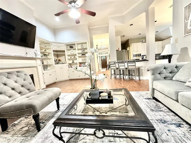 a living room with furniture fireplace and wooden floor
