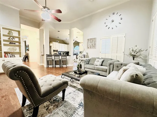 a large kitchen with stainless steel appliances lots of counter space and wooden floor